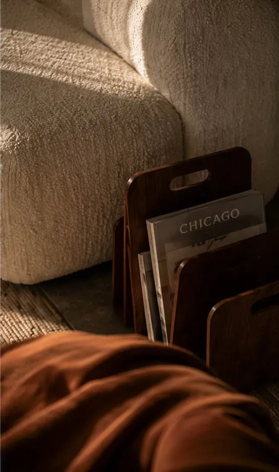 HM Living Room magazine rack and boucle armchair detail