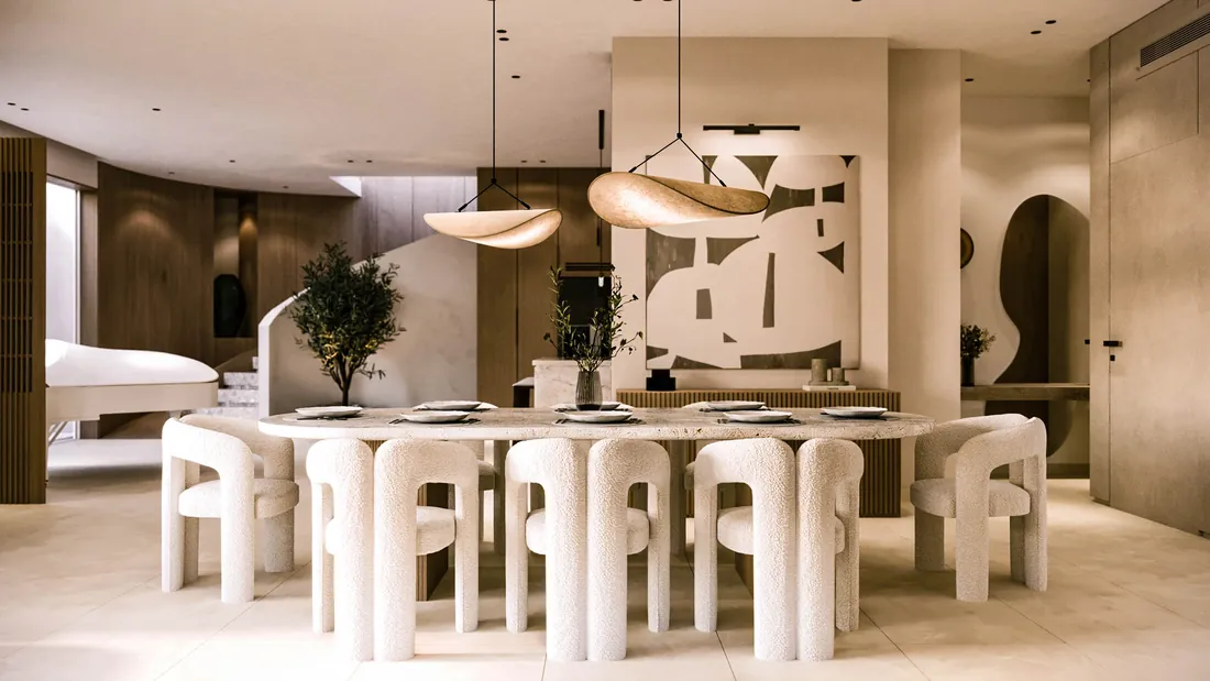 AK Home dining area with travertine table, boucle chairs and abstract artwork