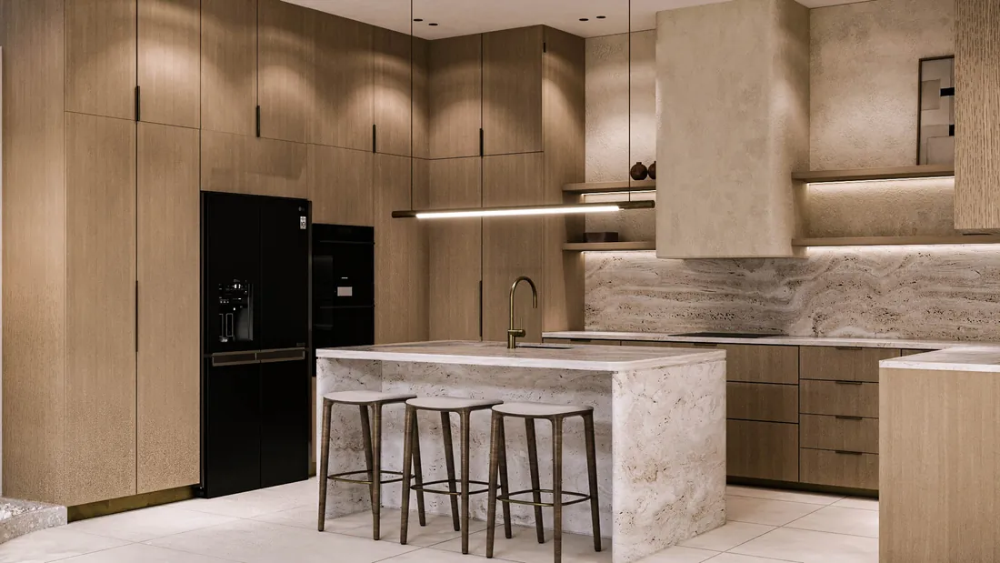 AK Home kitchen with oak cabinetry and travertine island, angled view